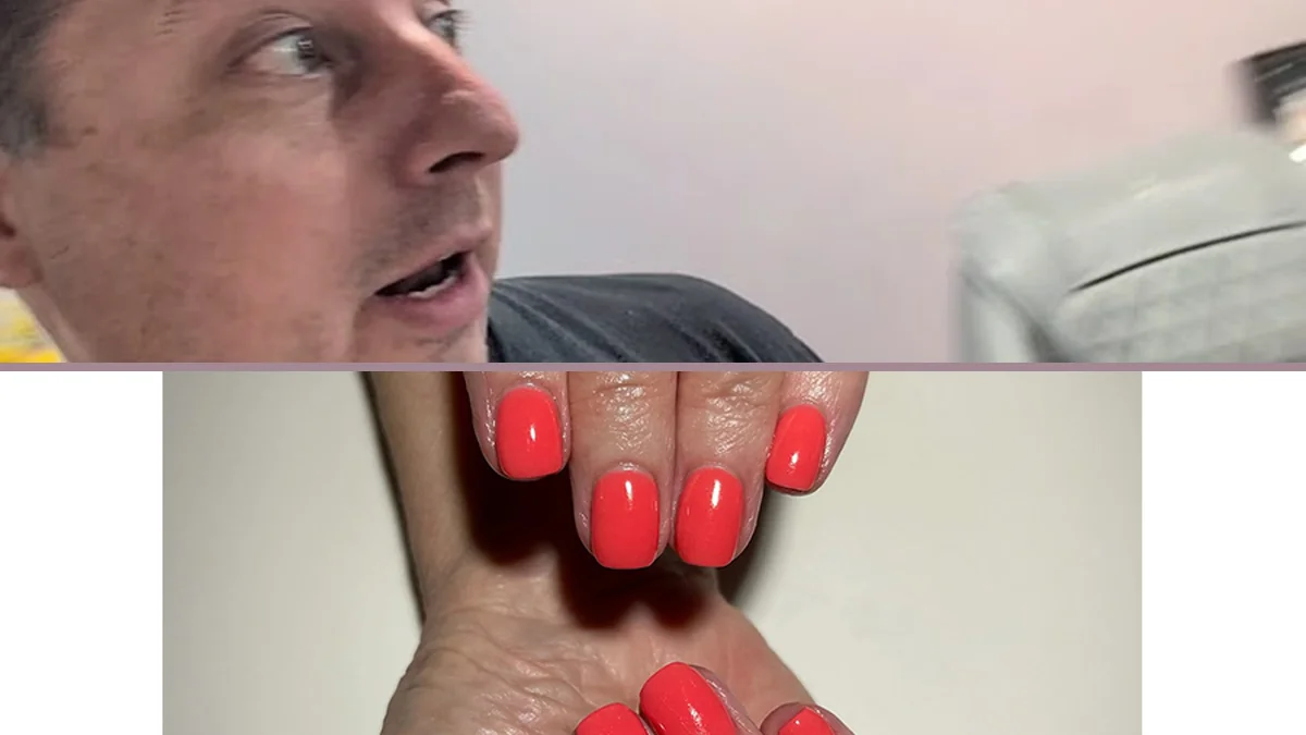 Manicured hands beside polish bottles